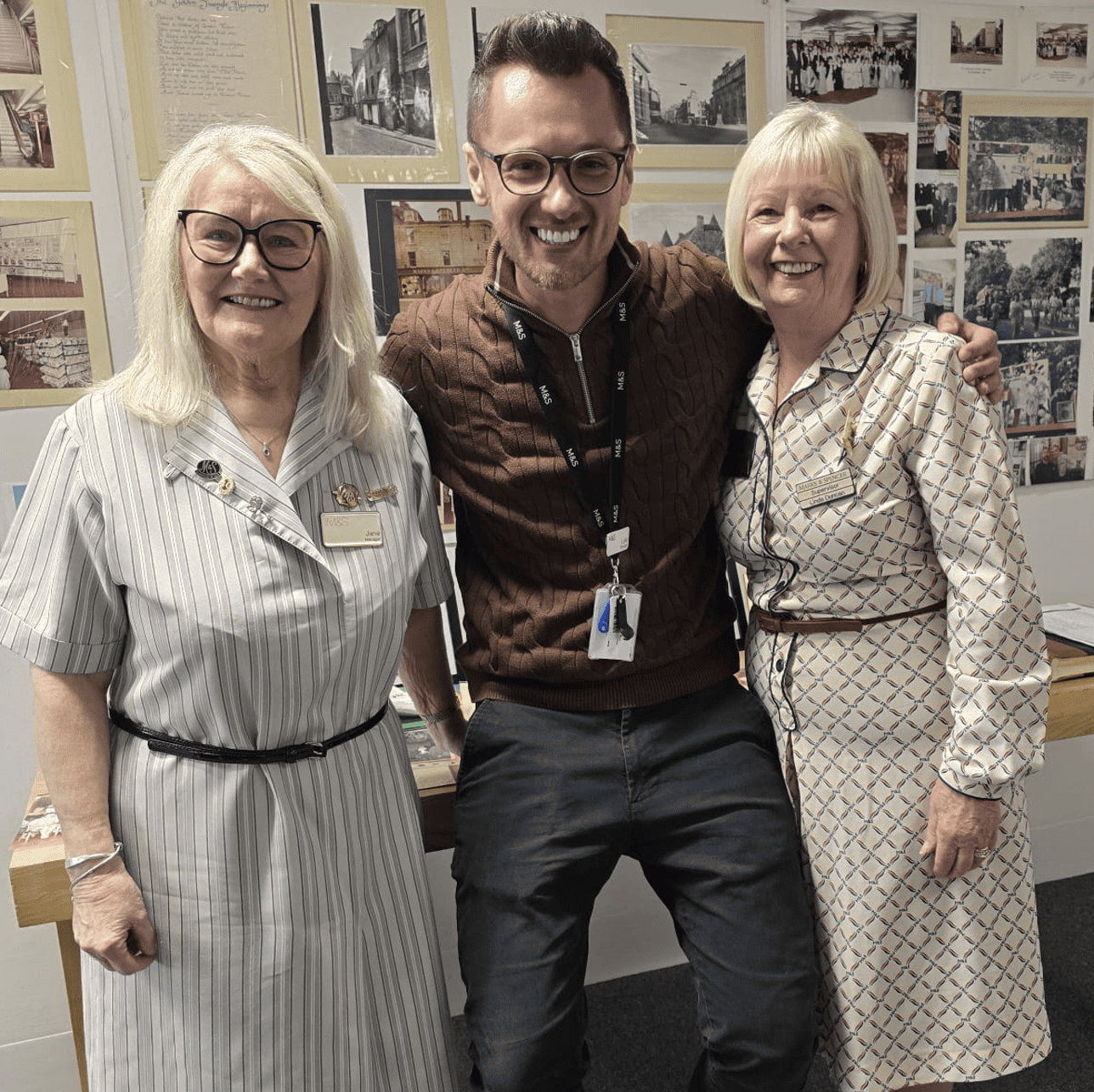 Three people smiling into the camera