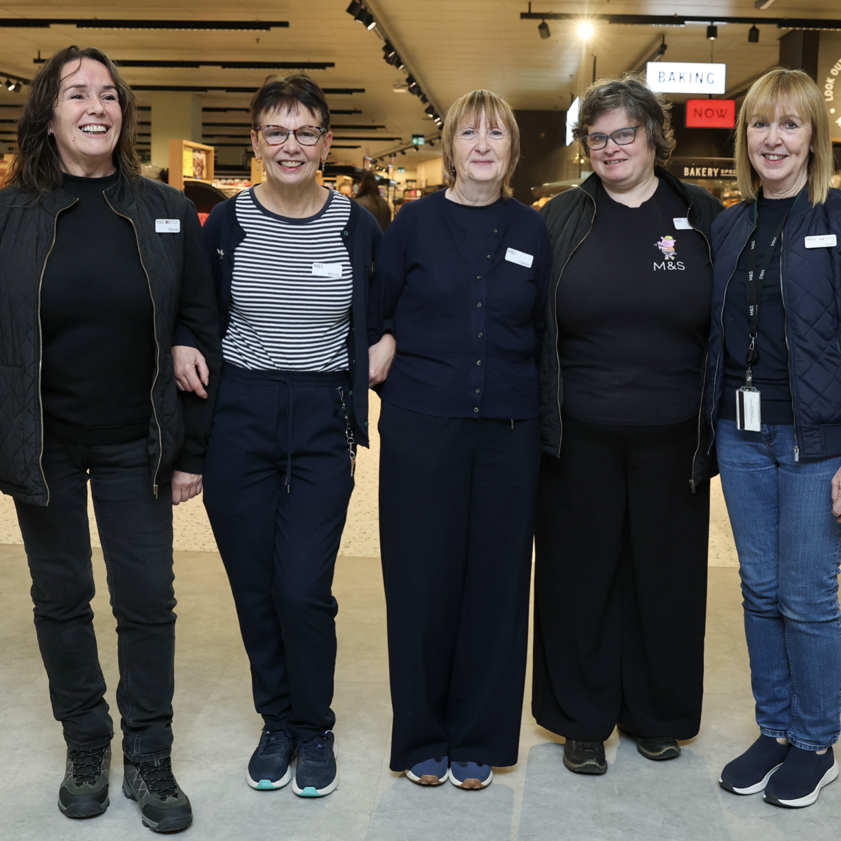 five people smiling at the camera