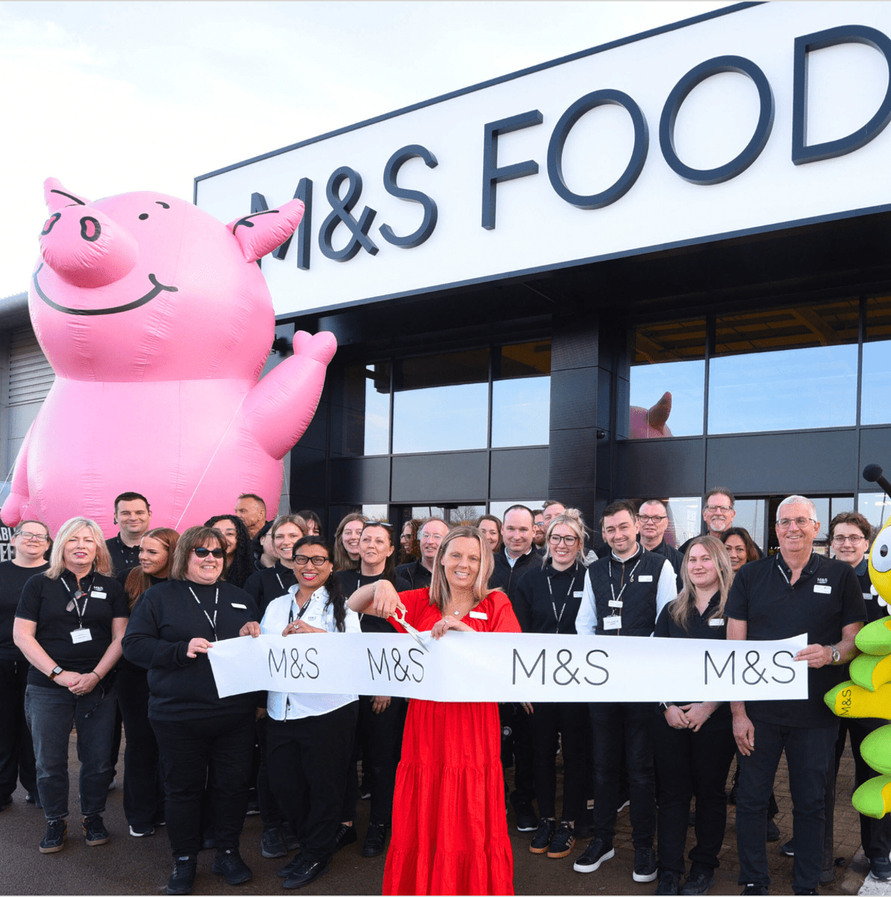 A blow up big mascot in front of a crown of people
