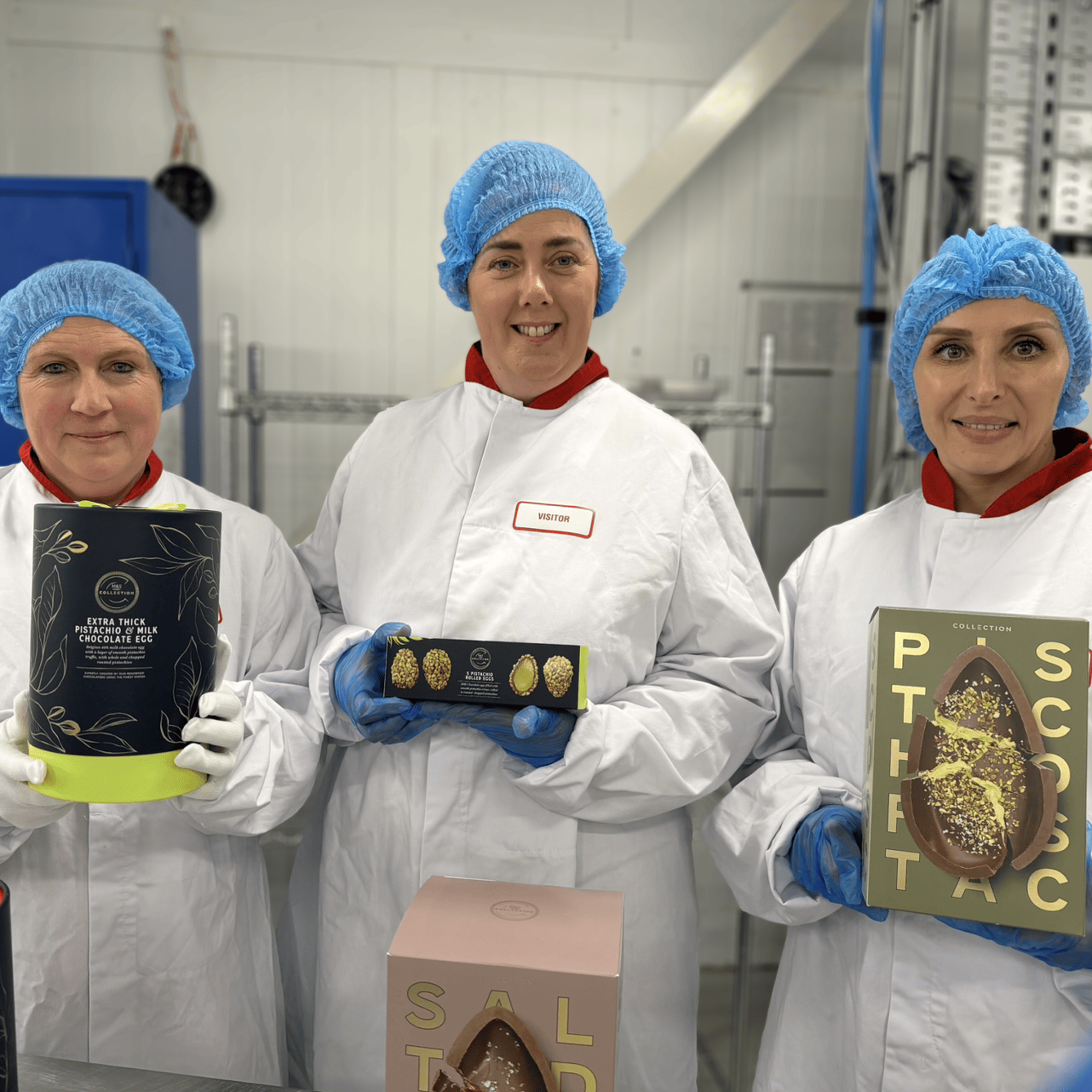 Three people holding chocolate easter eggs