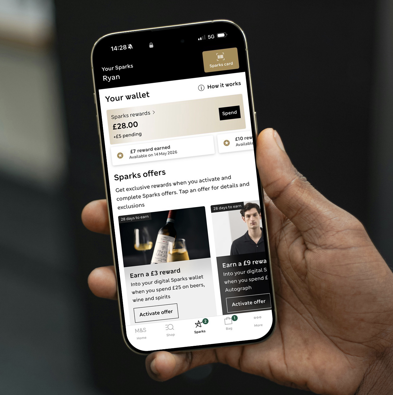 a hand holding a mobile phone showing the Sparks application