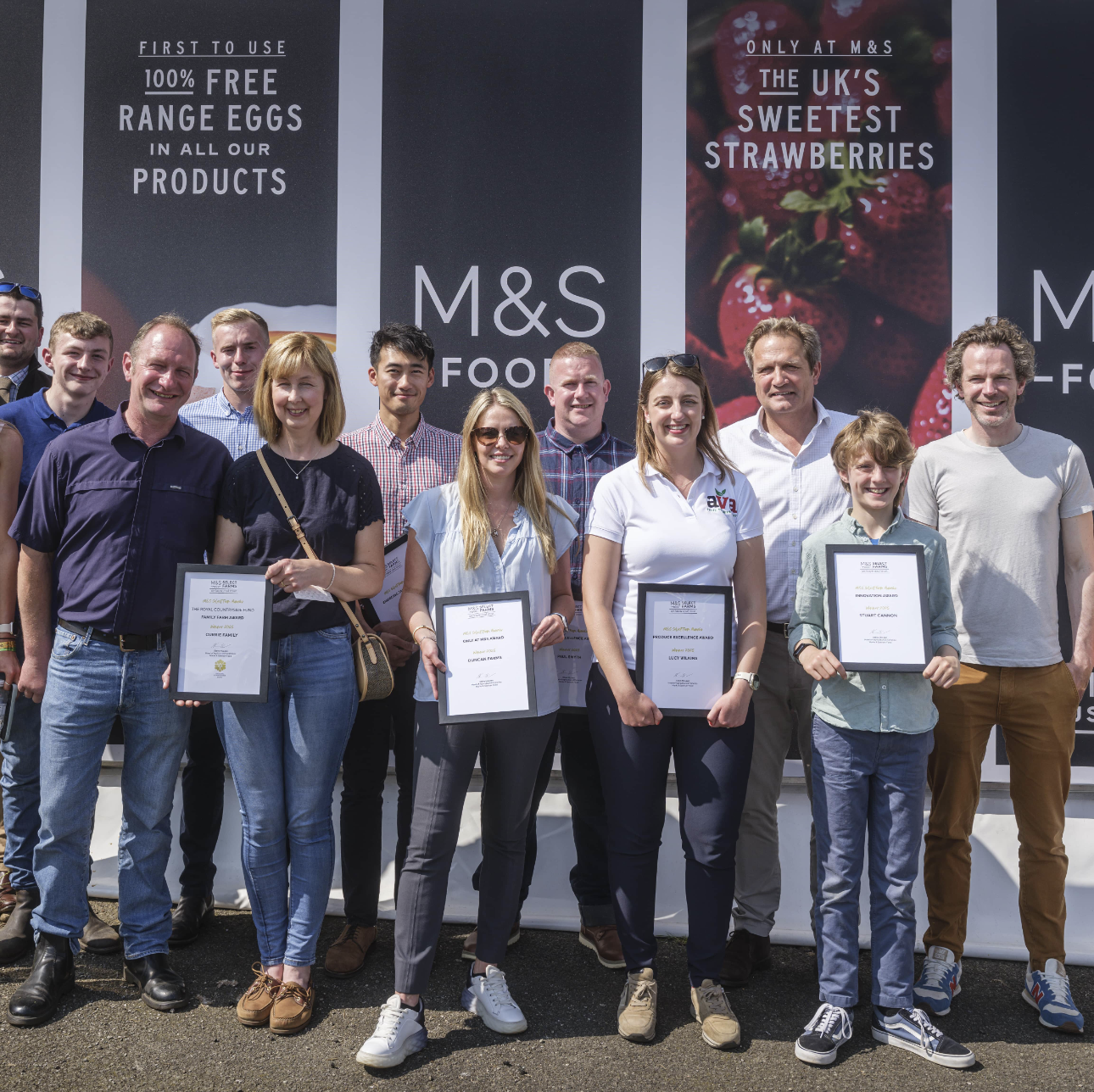 A group of people holding award certificates