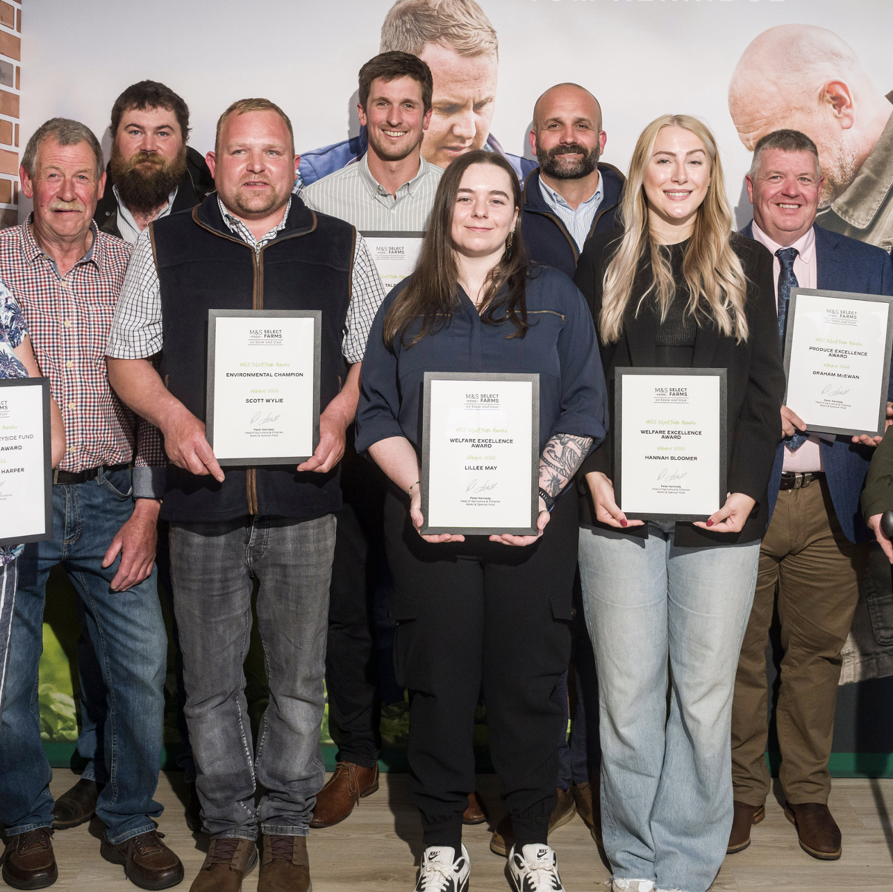 a group of people holding awards