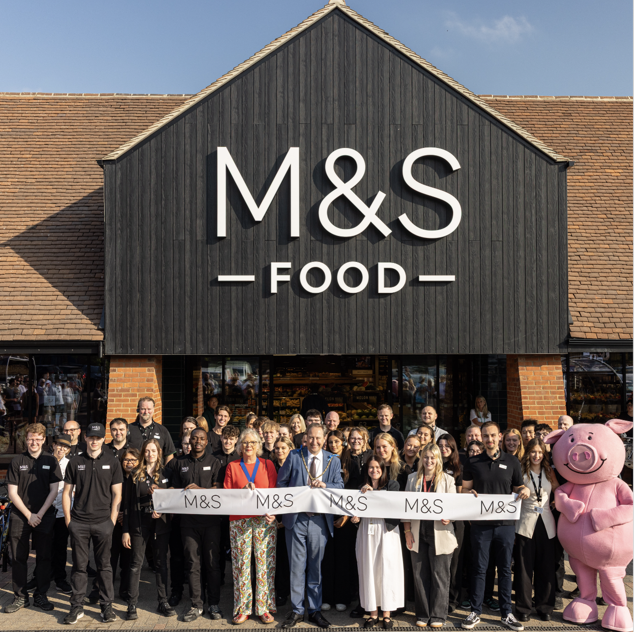 an M&S food store with a group of people standing outside