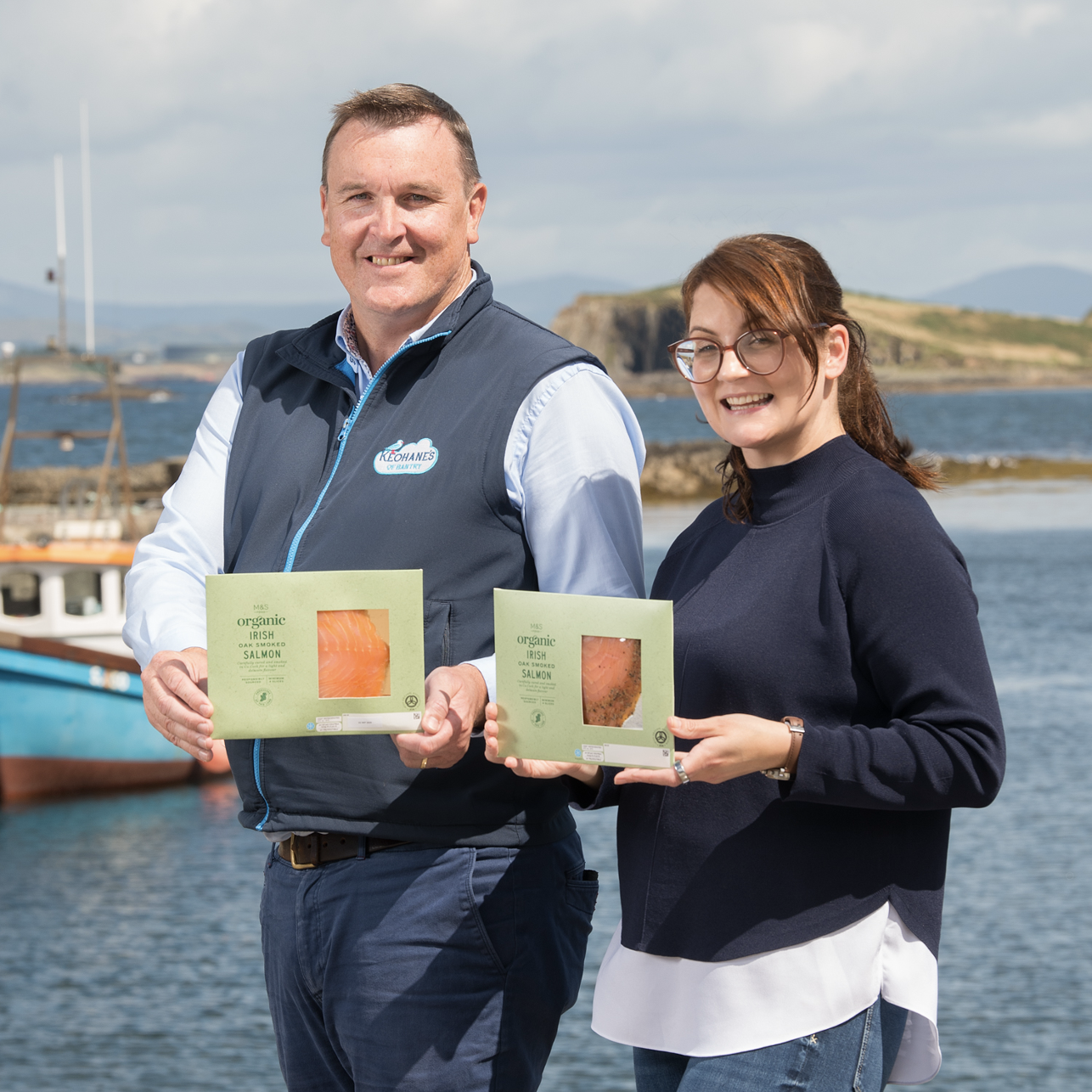two people holding packets of salmon