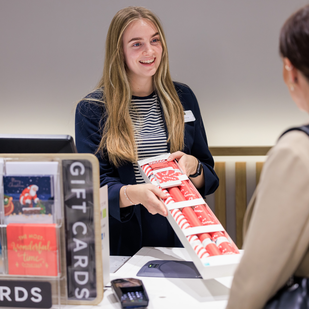Customer service assistant serving a customer