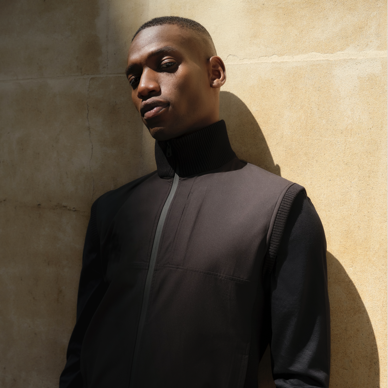 A person leaning against the wall