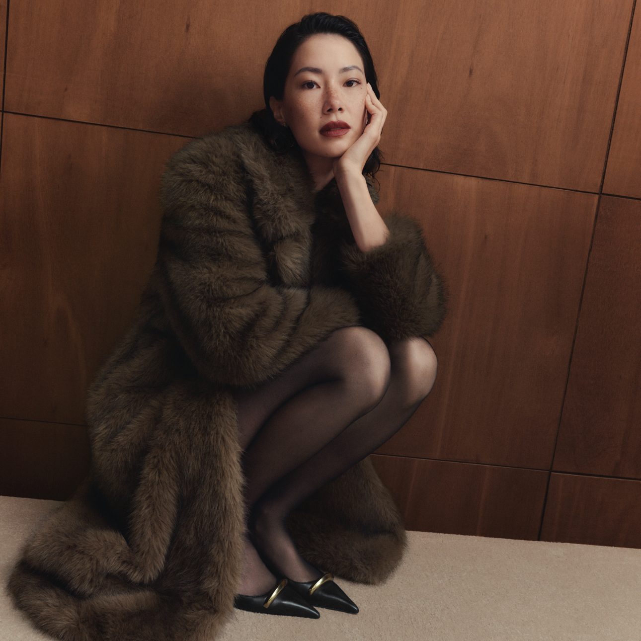 A person wearing a brown fur coat