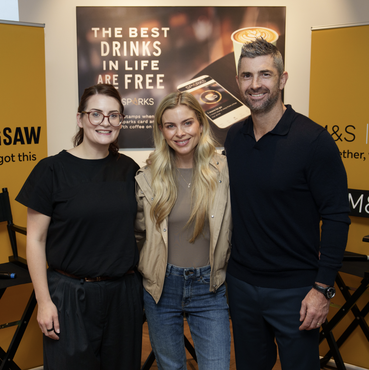 three people in front of a Jigsaw charity logo smiling at the camera