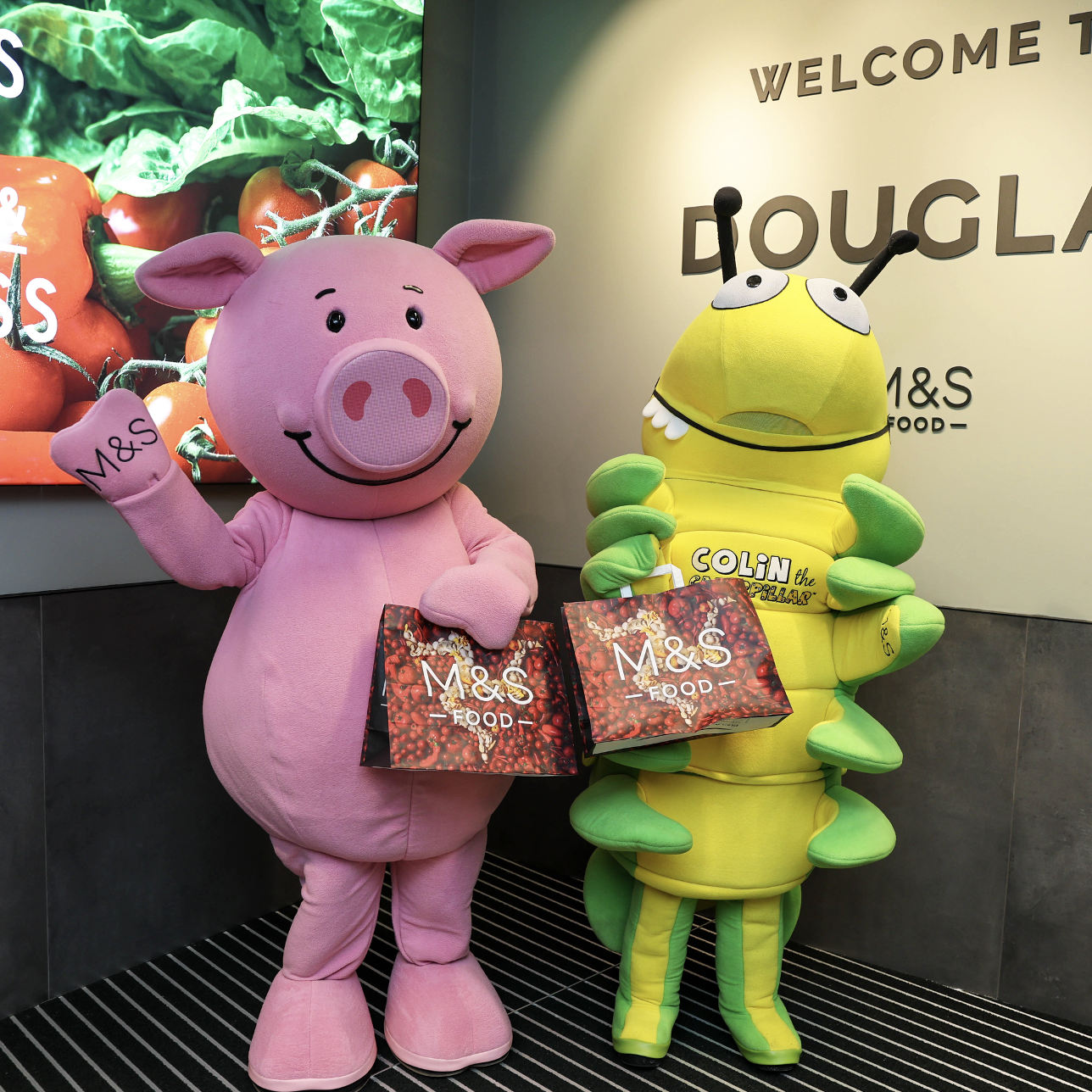 A pink pig mascot and yellow and green caterpillar mascot