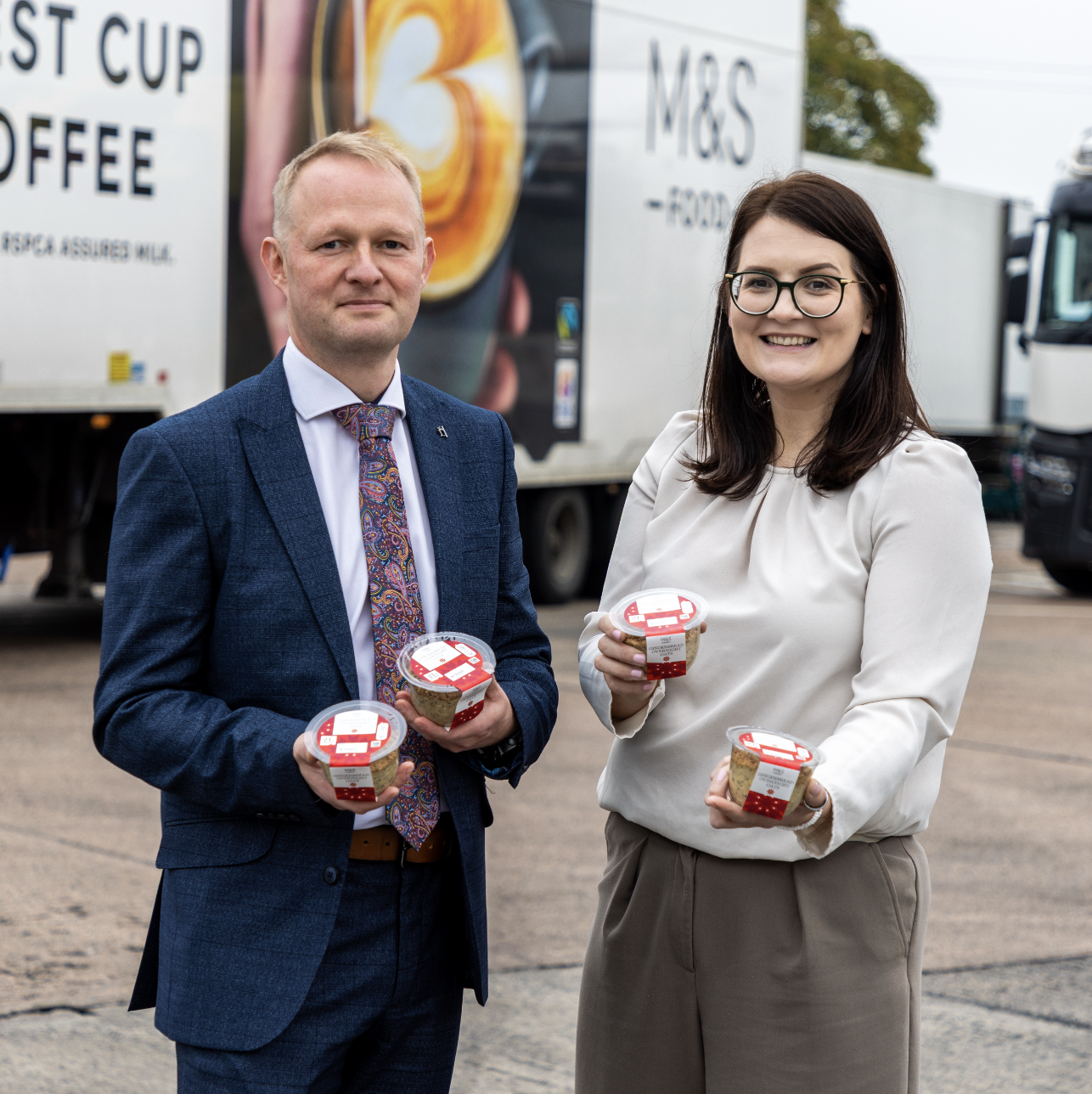 two people holding overnight oat breakfast pots