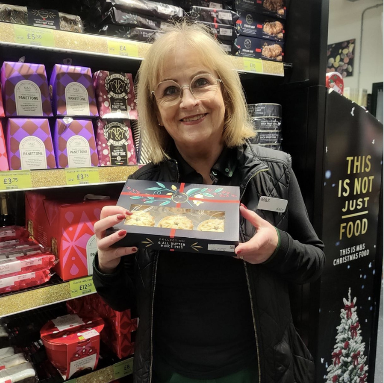 a person holding a box of mince pies