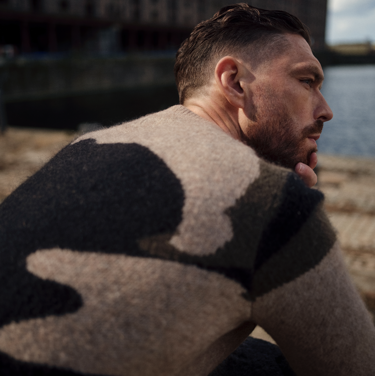 a person wearing a cream and brown woollen jumper