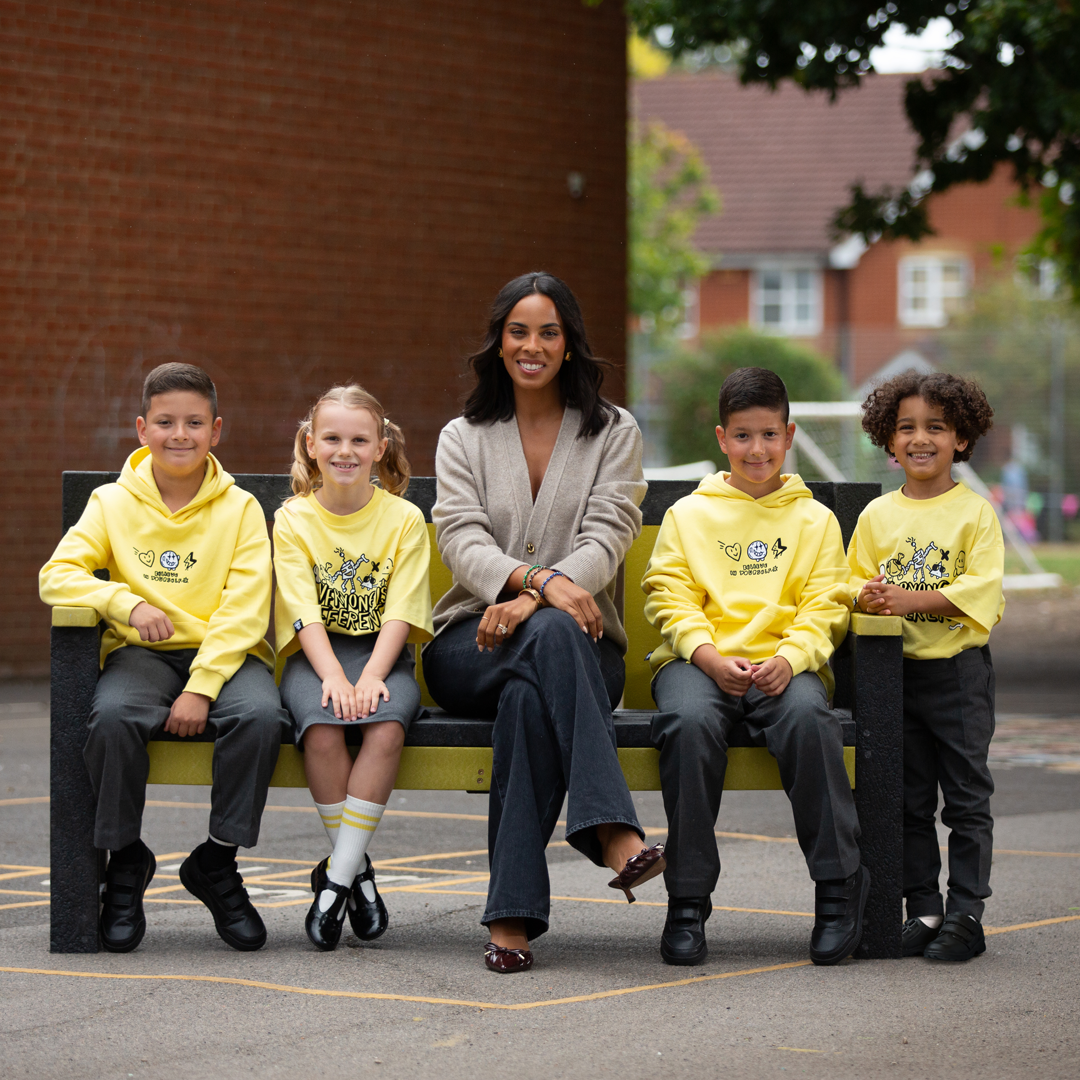 Rochelle Humes sitting with children on a bench all wearing yellow