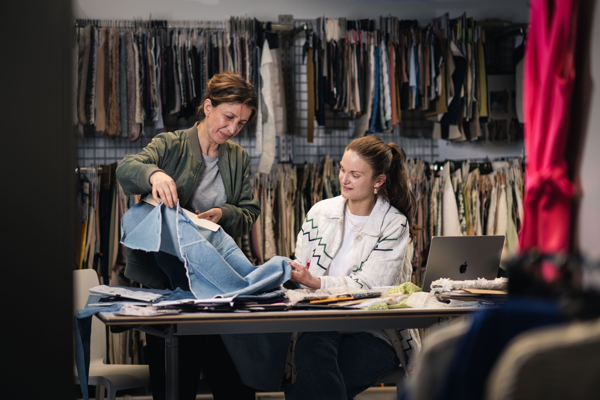 Two people working together on making clothes