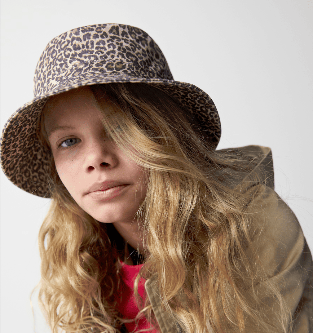A young girl wearing a bucket hat