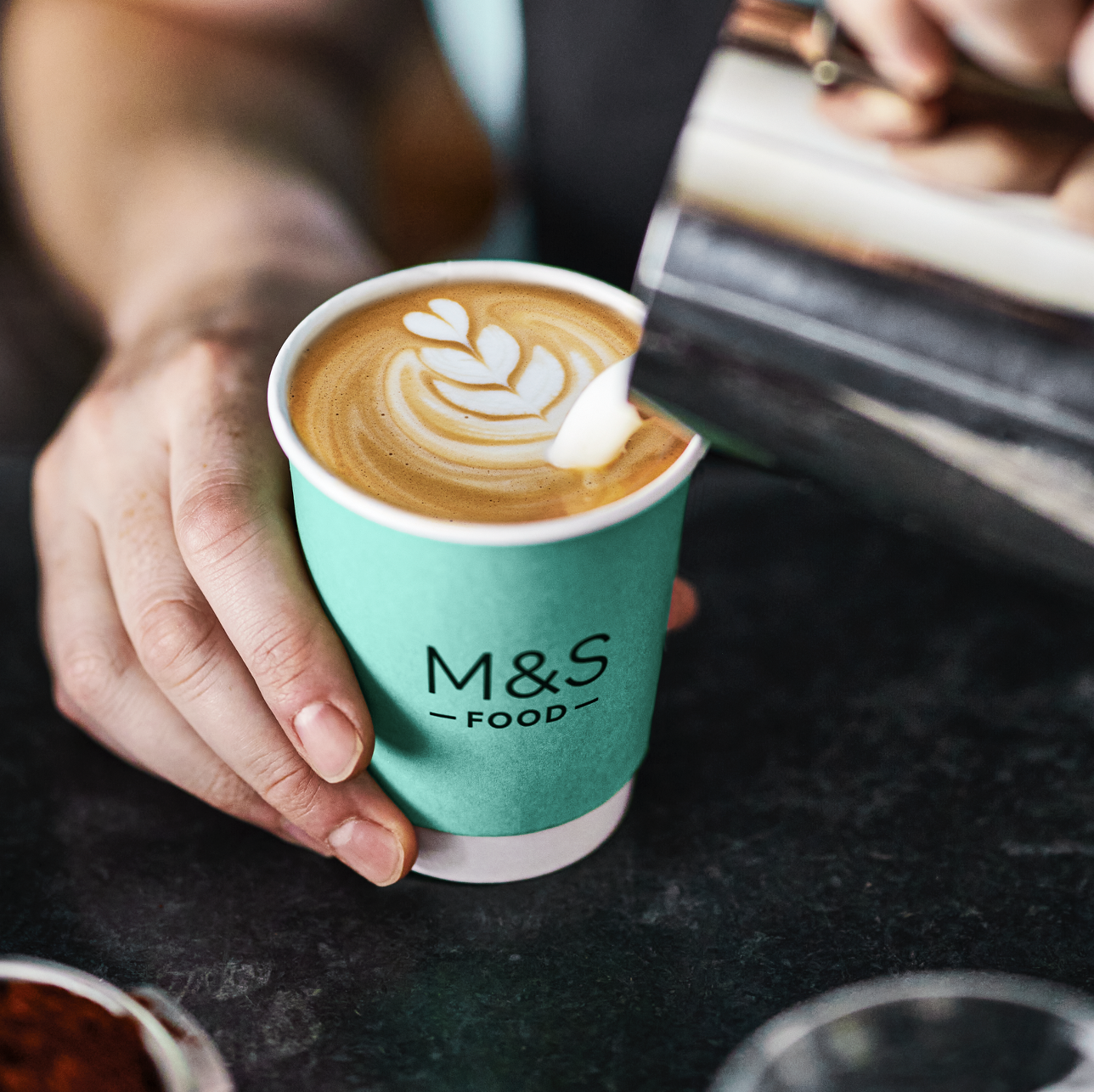 A person pouring coffee