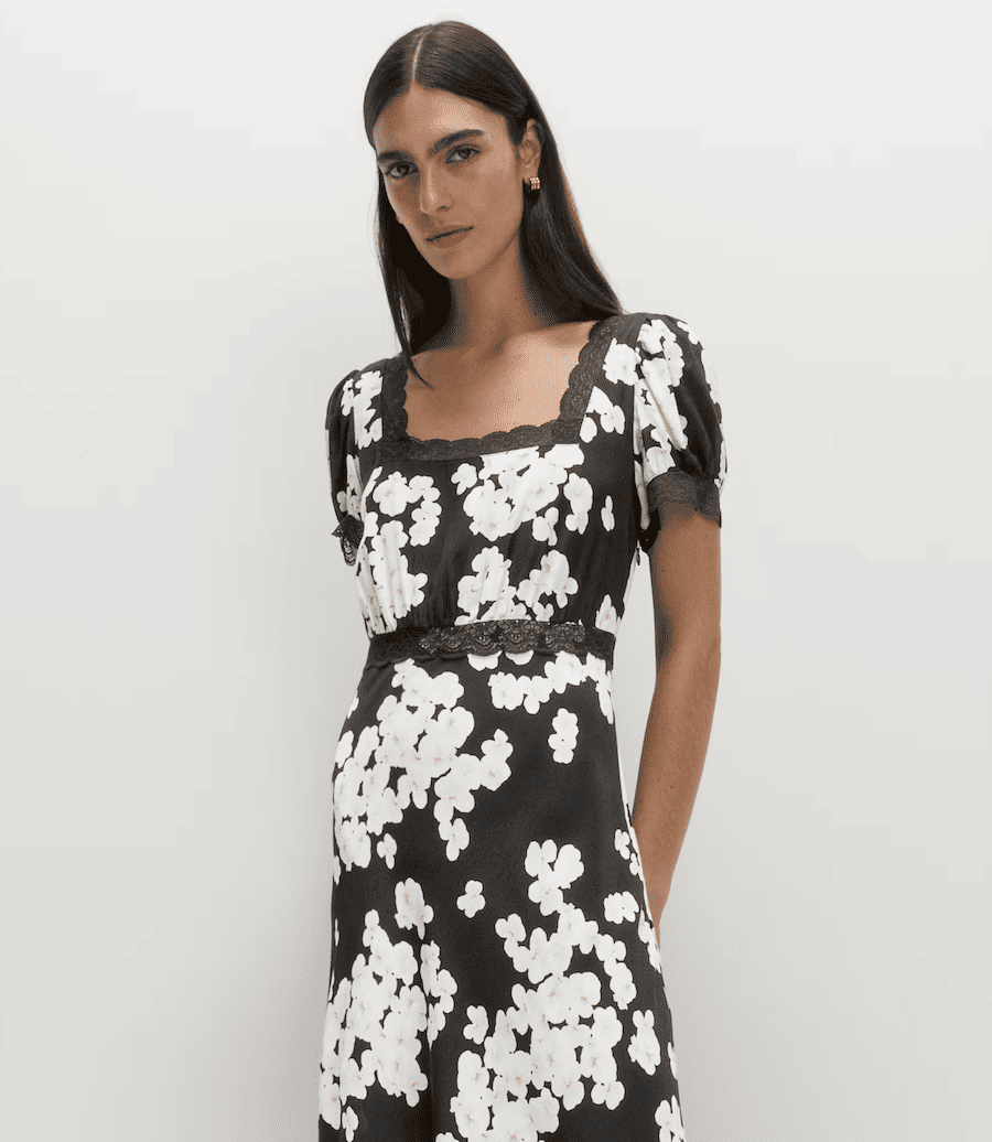 a woman in a floral black and white dress