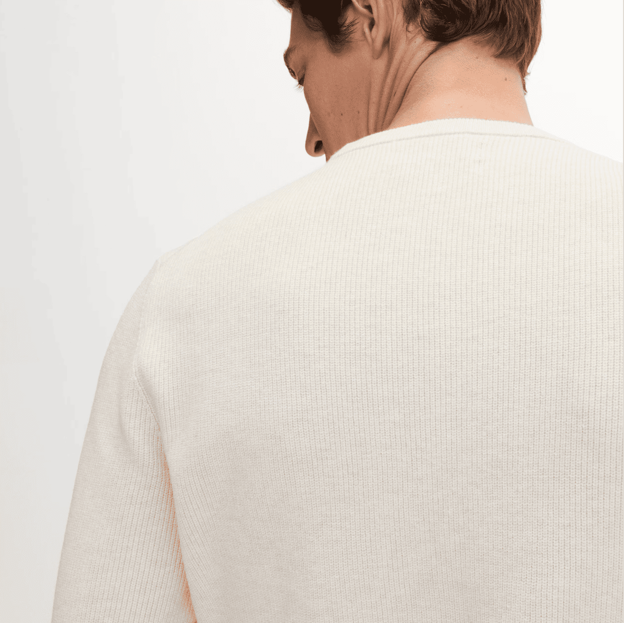 A person in a white cotton jumper