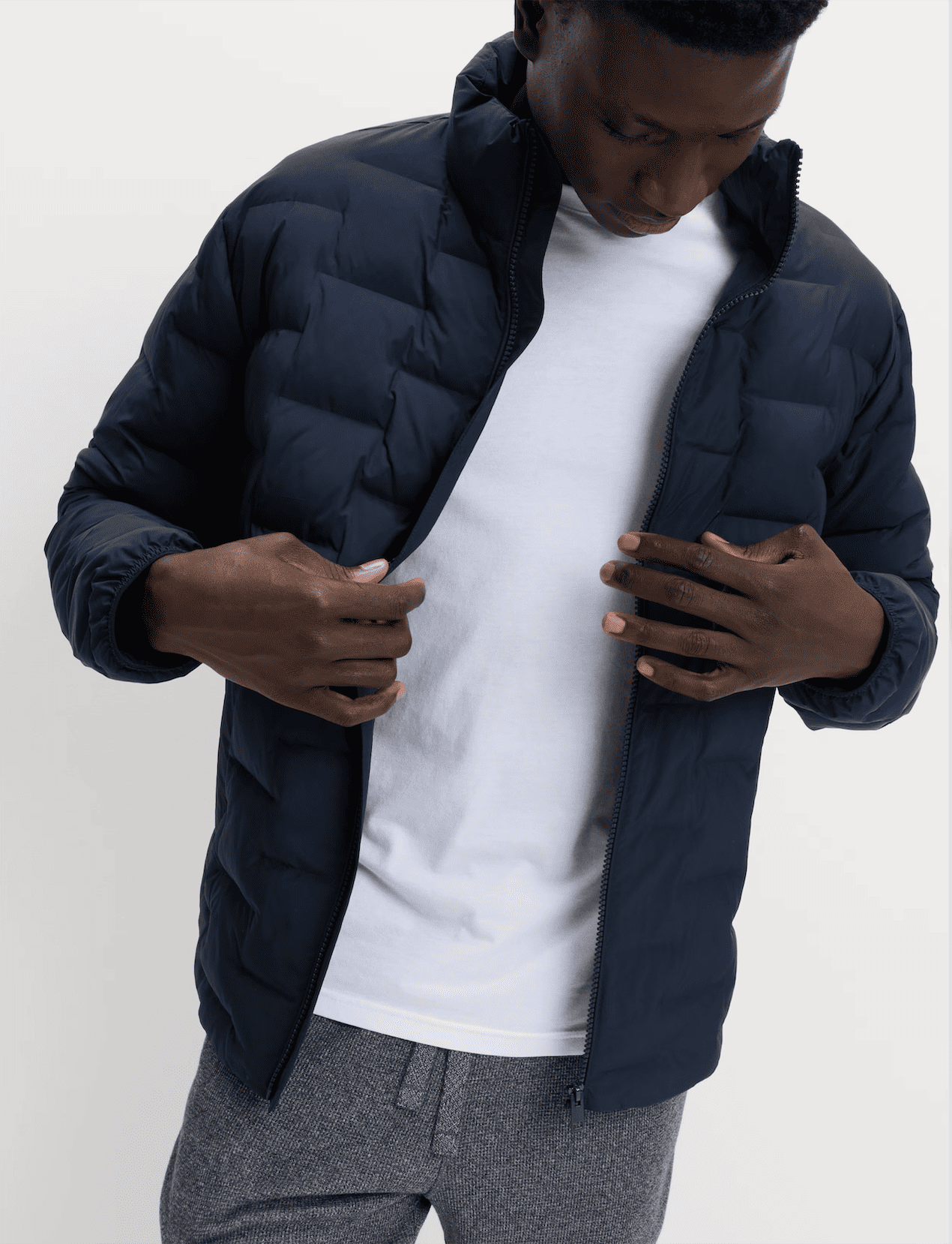 A person wearing a navy puffer jacket