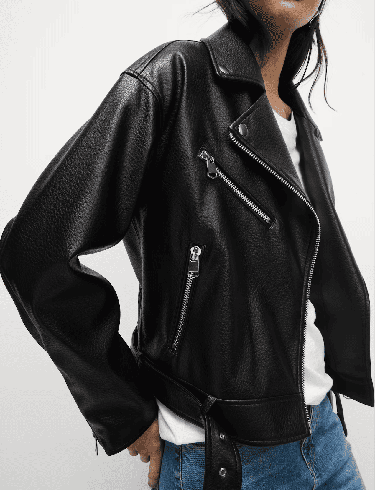 A person wearing a black leather biker jacket