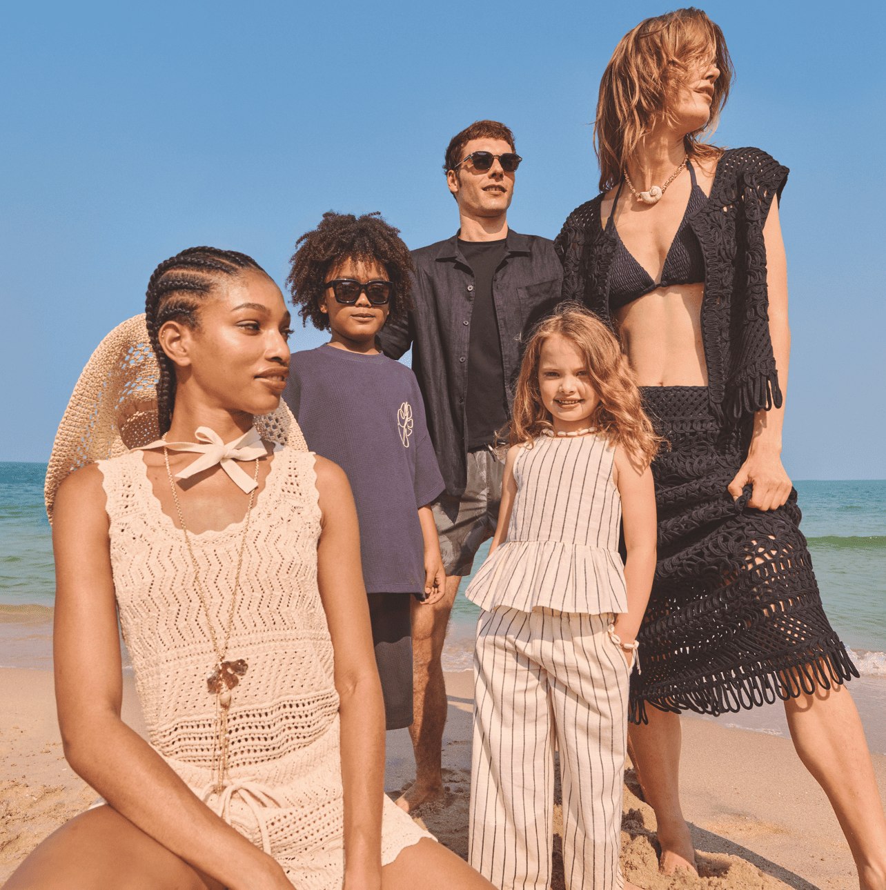 A group of adults and children on a beach