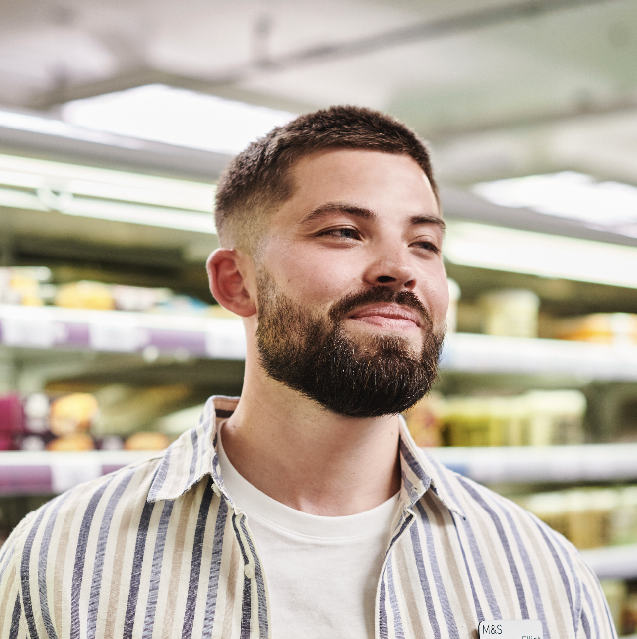 A person in a striped shirt smiling