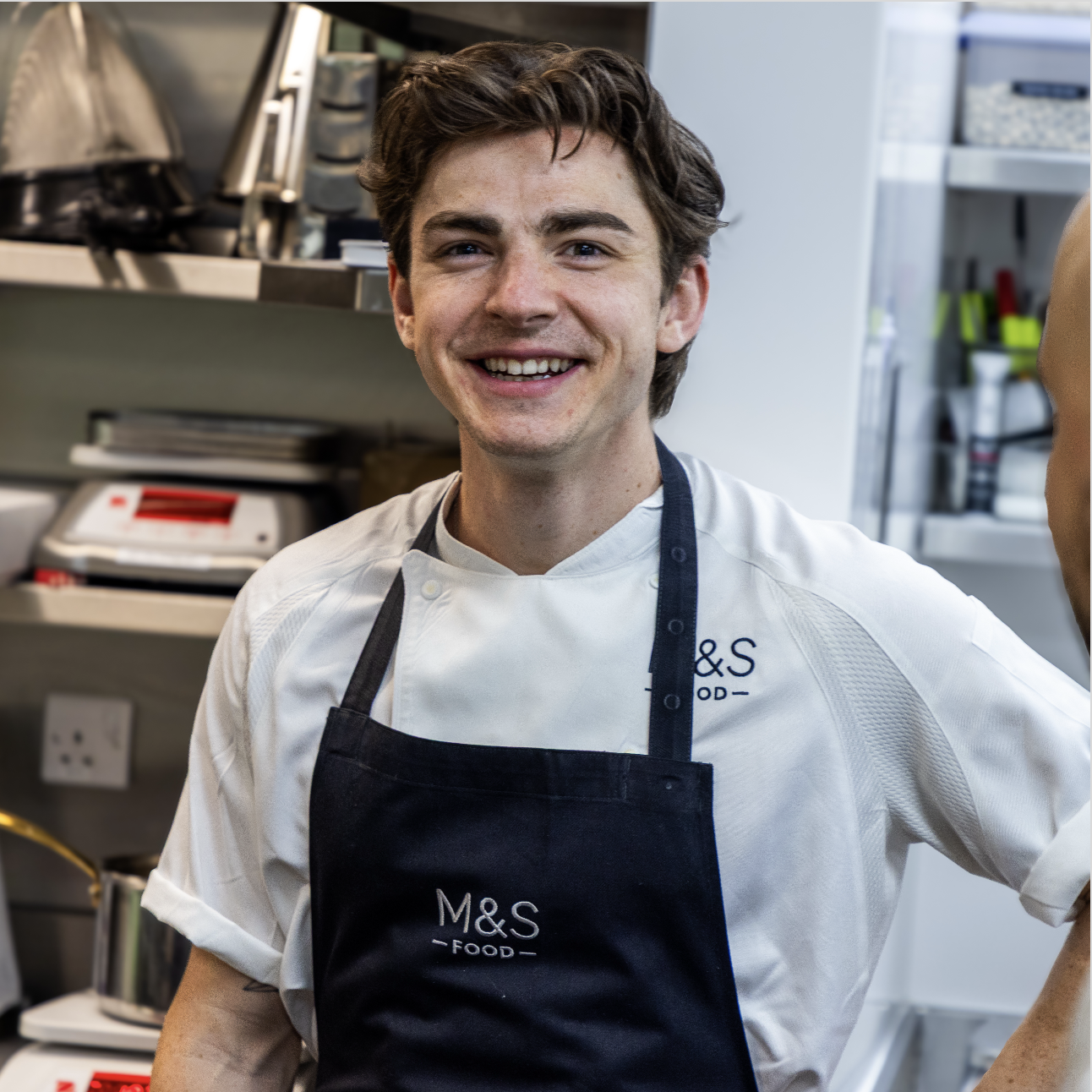 An M&S chef smiling at the camera.